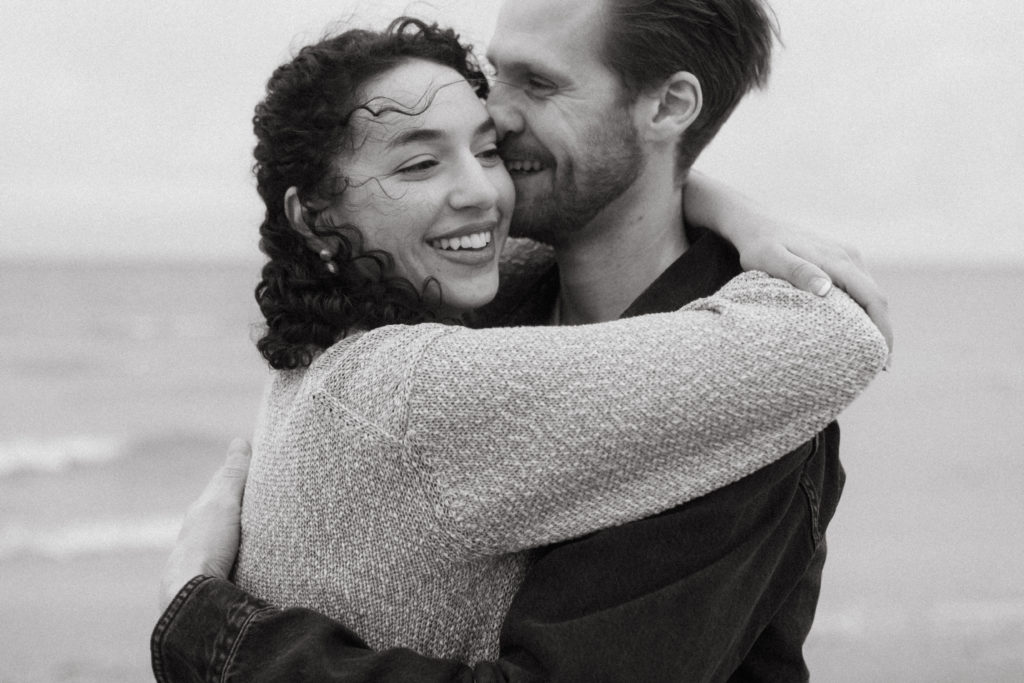 couple hugging at Southwick beach during a photography session